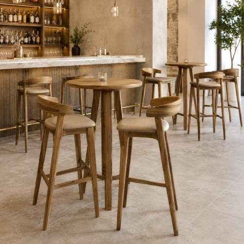 Wooden bar-height tables and matching bar stools in a modern bar setting