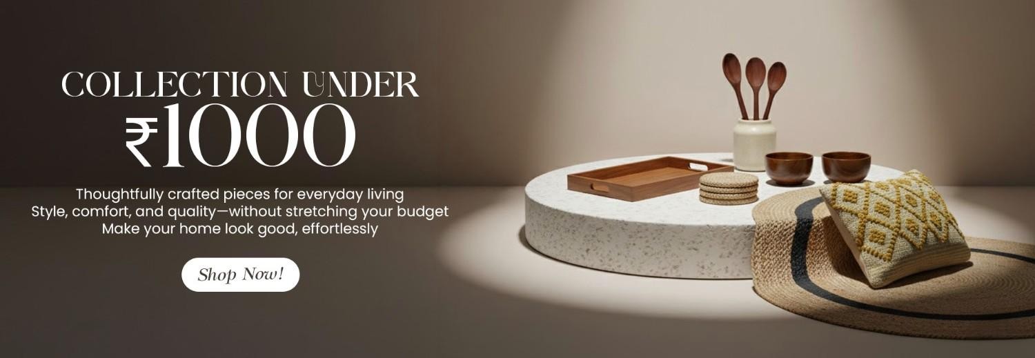 Affordable home décor collection under ₹1000 with wooden serving tray, ceramic bowls, wooden spoons, coasters, woven placemat, and decorative cushion.